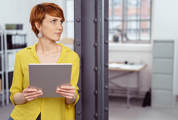 Woman in an office holding a tablet